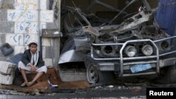 A boy sits next to a car destroyed by a Saudi-led air strike in Yemen's northwestern province of Amran, Aug. 29, 2015. (REUTERS/Khaled Abdullah)