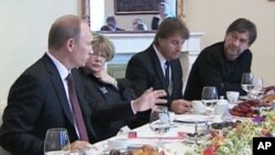 Russian Prime Minister Vladimir Putin, left, responds to questions from rock musician Yuri Shevchuk, right