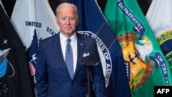 Joe Biden leaves after addressing the Intelligence Community