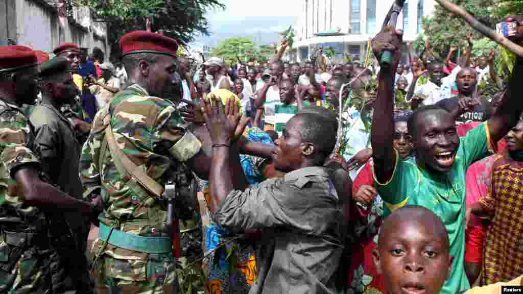 People greet soldiers as they celebrate in Bujumbura, Burundi, May 13, 2015.
