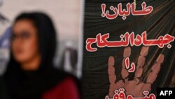 Afghan women take part in a gathering against the claimed human rights violations on women by the Taliban regime in Afghanistan, at a hall in Kabul, Aug. 2, 2021 