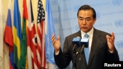 FILE - China's Foreign Minister Wang Yi speaks to members of the media after the U.N. Security Council meeting on Syria at the 68th United Nations General Assembly in New York.