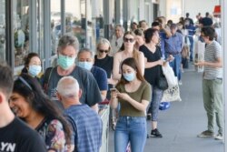 People queue at a supermarket after the South Australian state government announced a six-day lockdown because of a Covid-19 coronavirus outbreak in Adelaide on Nov. 18, 2020.