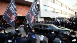 A hearse carrying the body of the late former South Korean President Chun Doo-hwan leaves a funeral hall in Seoul, South Korea, Nov. 27, 2021.